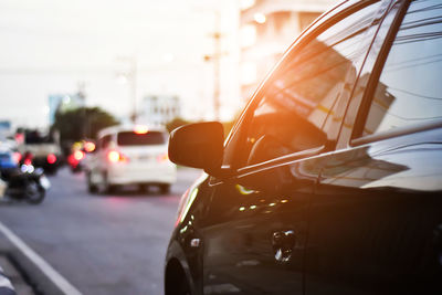 View of traffic on road at sunset