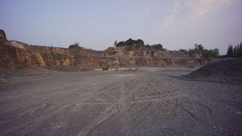 Scenic view of arid landscape against sky