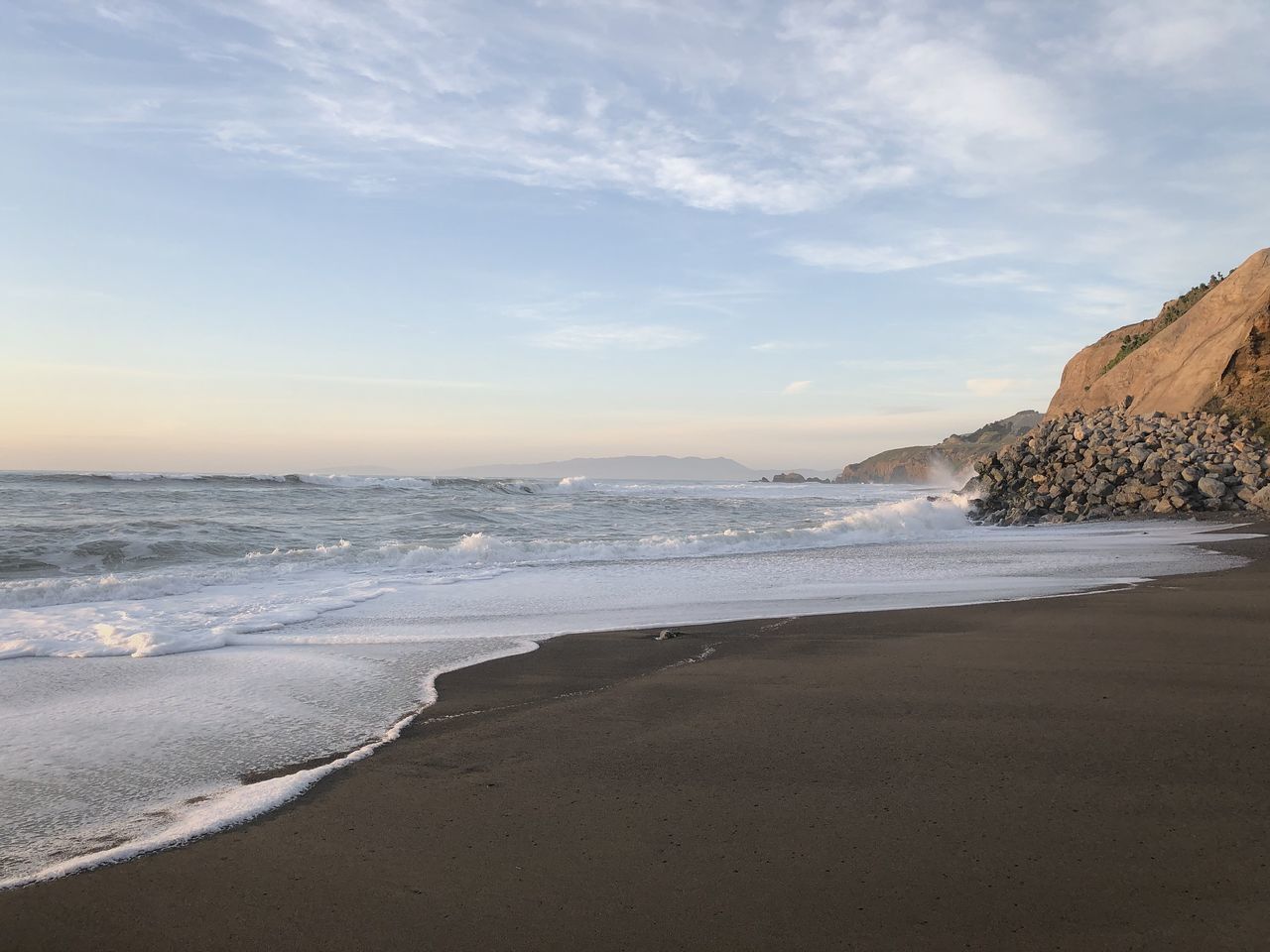 SCENIC VIEW OF BEACH AGAINST SKY DURING SUNSET