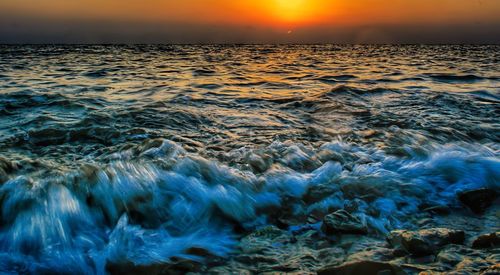 Close-up of sea against sky at sunset