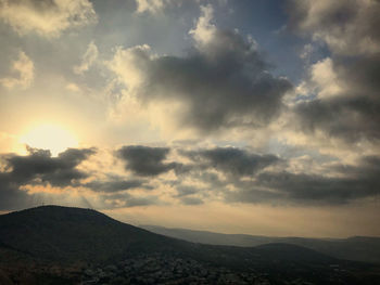 Scenic view of mountains against dramatic sky