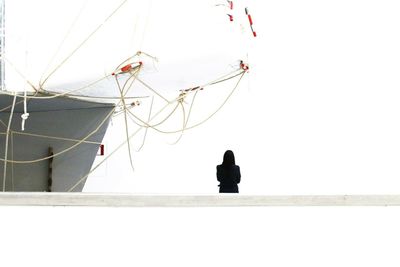 Low angle view of woman against clear sky