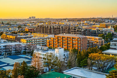 High angle view of buildings in city against sky during sunset