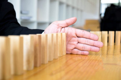 Close-up of man playing piano on table