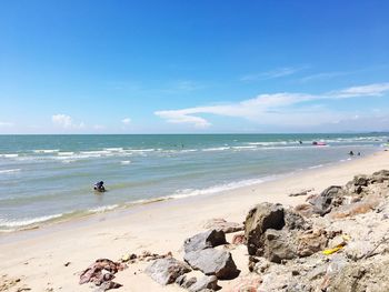 Scenic view of beach against blue sky