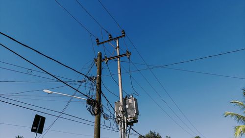 Electricity poles and cables in the afternoon