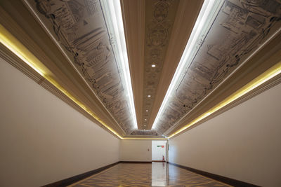 Low angle view of illuminated corridor in building