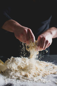 Cropped view of chef's hands kneading pastry