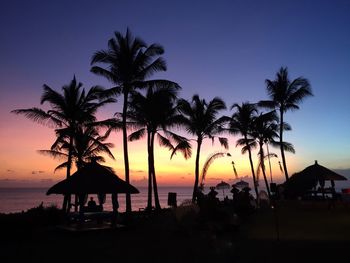 Silhouette of palm trees at sunset