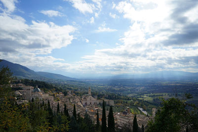 Aerial view of cityscape against cloudy sky
