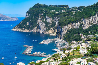 Landscape of capri island with marina grande harbour and punta del capo viewed from phoenician steps