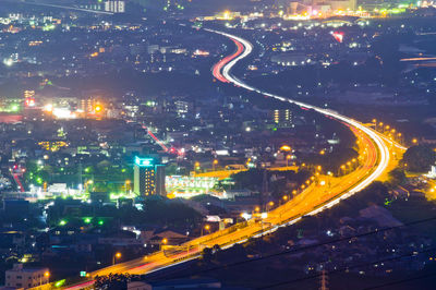 High angle view of illuminated buildings in city at night