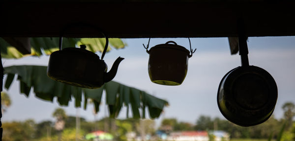 Low angle view of lighting equipment hanging against sky