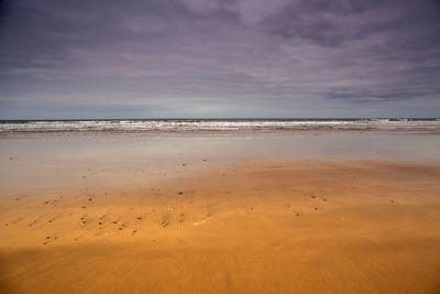 Scenic view of beach against sky