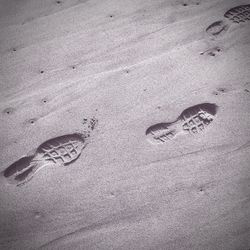 High angle view of footprints on sandy beach