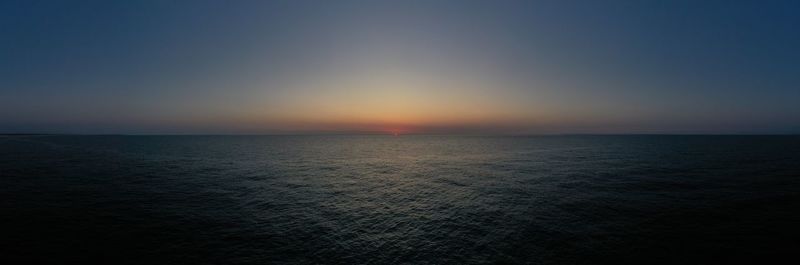 Scenic view of sea against clear sky during sunset