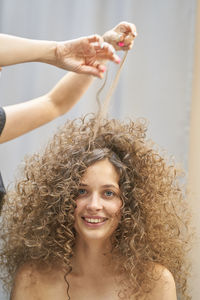 Portrait of young woman with curly hair