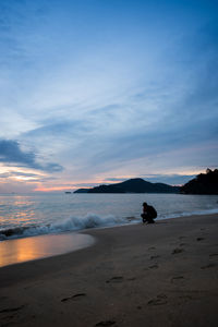 Scenic view of beach against sky during sunset