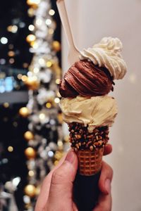 Close-up of hand holding ice cream cone