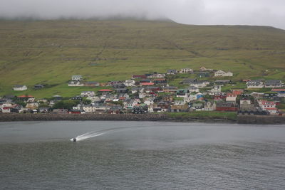 Scenic view of sea by town