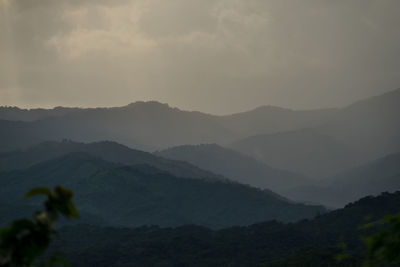 Scenic view of mountains against dramatic sky