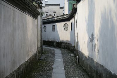 Footpath amidst buildings in city