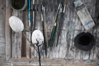 Creative eggs against paintbrush on table