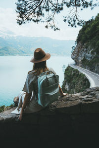 Woman looking at lake against sky