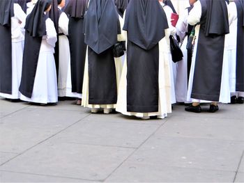 Low section of nuns standing on street