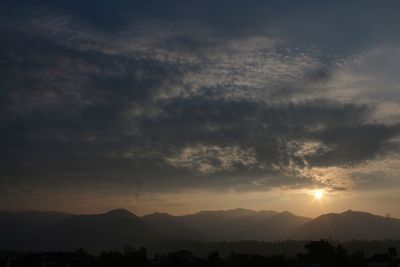 Scenic view of silhouette mountains against sky at sunset