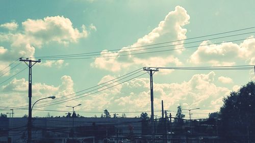 Low angle view of power lines against sky