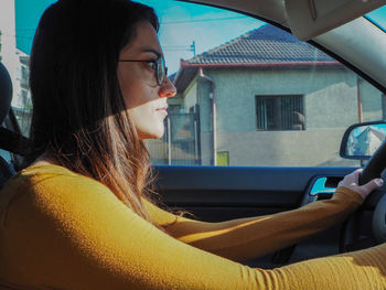 Portrait of woman sitting in car