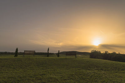 Scenic view of field against sky during sunset