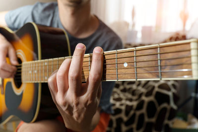 Close-up of man playing guitar