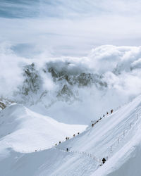 Scenic view of snow covered mountains against sky