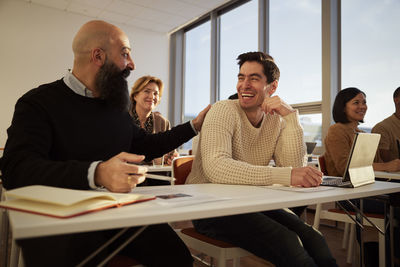 Group of adults sitting in class and laughing