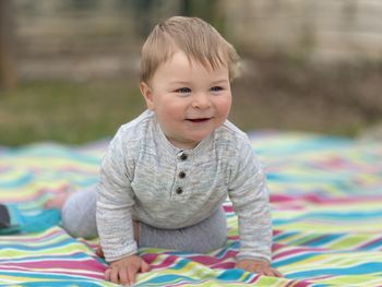 Portrait of cute baby boy sleeping on bed