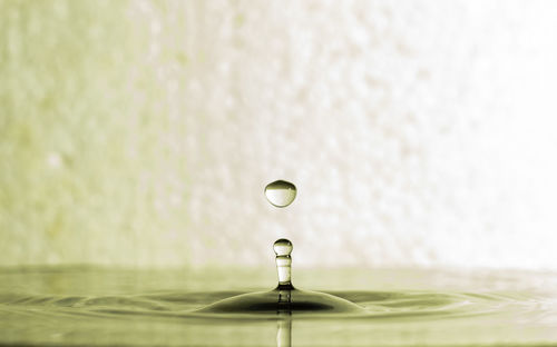 Close-up of drop falling on water surface