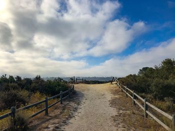 Hiking walkway path with bench with foliage and blue sky in encinitas in san diego, california
