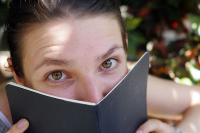 Close-up portrait woman holding book