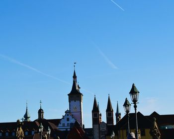 Low angle view of city against clear blue sky