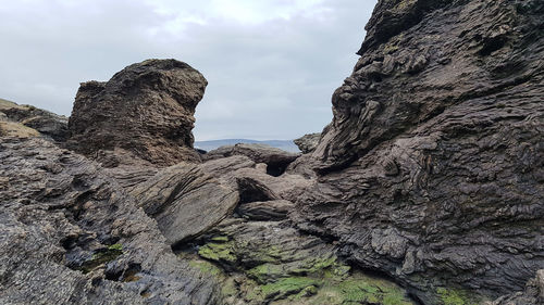 Low angle view of rock formation against sky