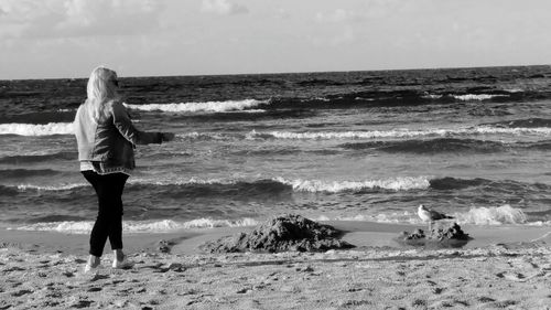 Rear view of man standing on beach