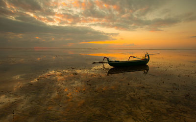 Boats moored at sunset