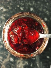 High angle view of red rose in glass