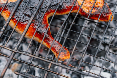Close-up of orange food on barbecue grill