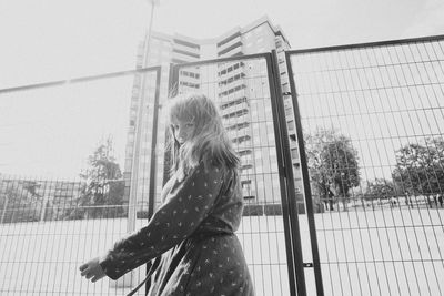 Low angle view of young woman standing on field