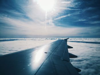 Airplane wing against sky