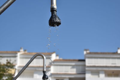 Close-up of water drop against sky