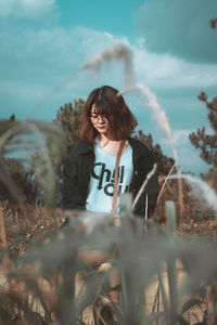 Young woman standing on field